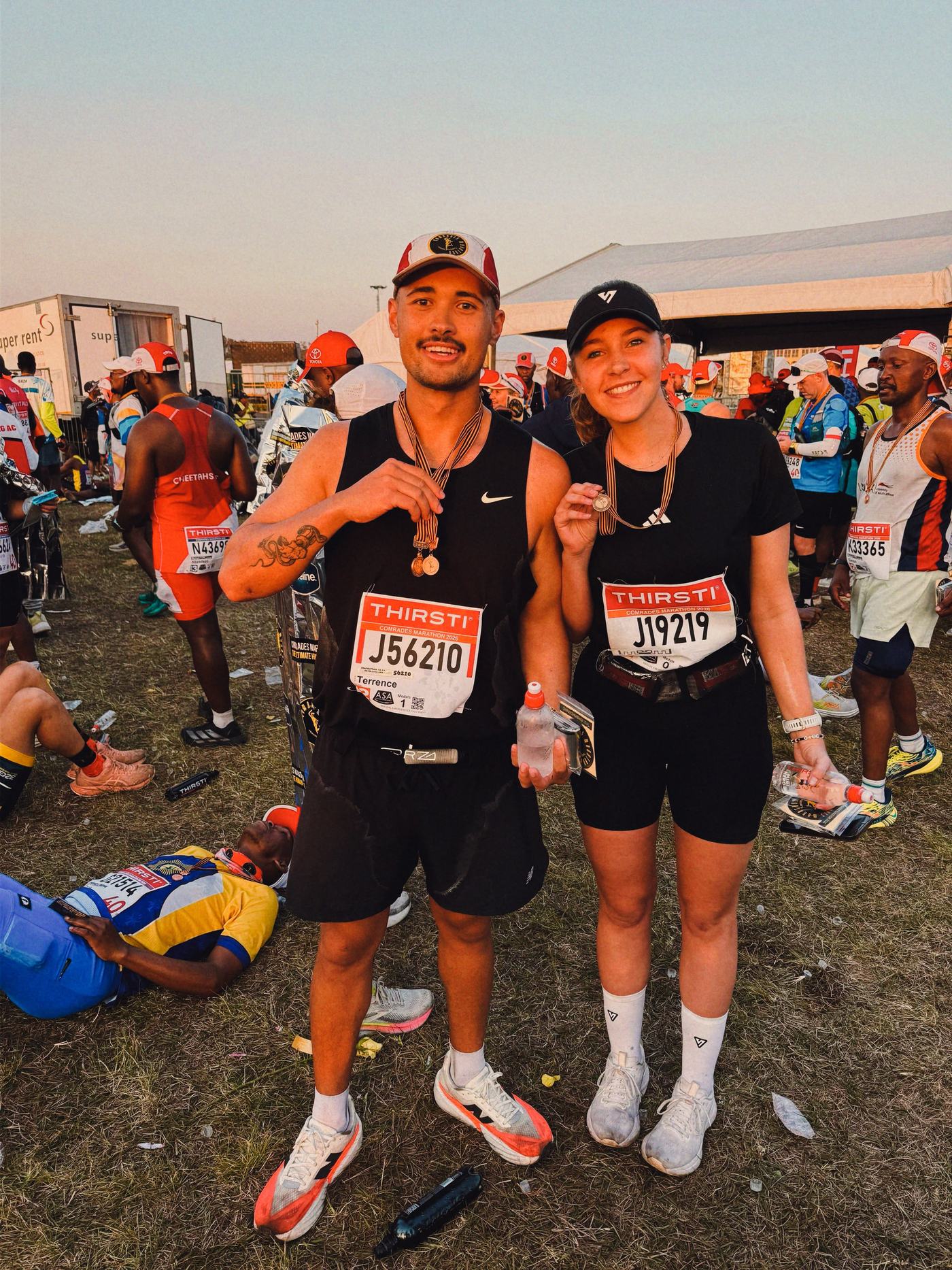 Terrence and a fellow runner at the Comrades Marathon 2026 finish, each holding a finisher medal.