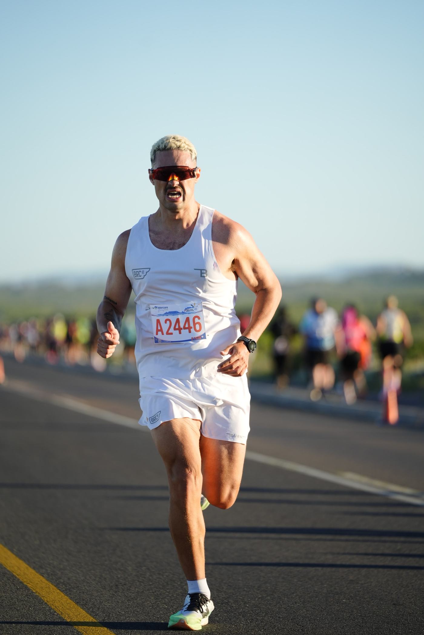 Terrence racing on an open road in a red vest, focused on the run ahead.